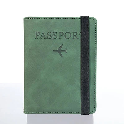 A dark green passport organizer wallet with a black strap and a stylized airplane icon.