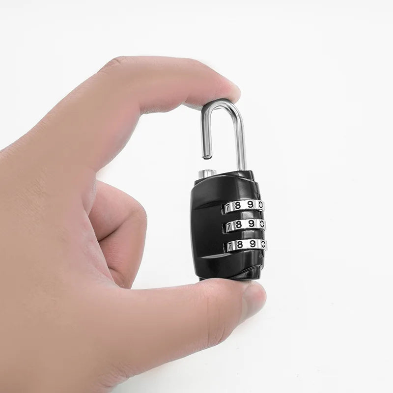 A hand holds a black 3-dial combination padlock with a silver shackle.
