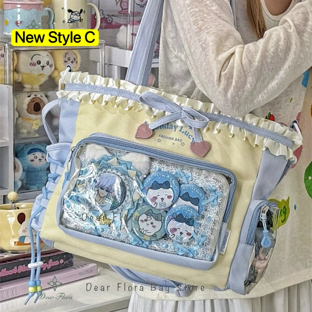 A light yellow and blue transparent shoulder tote bag decorated with cute animal stickers and fabric accents.