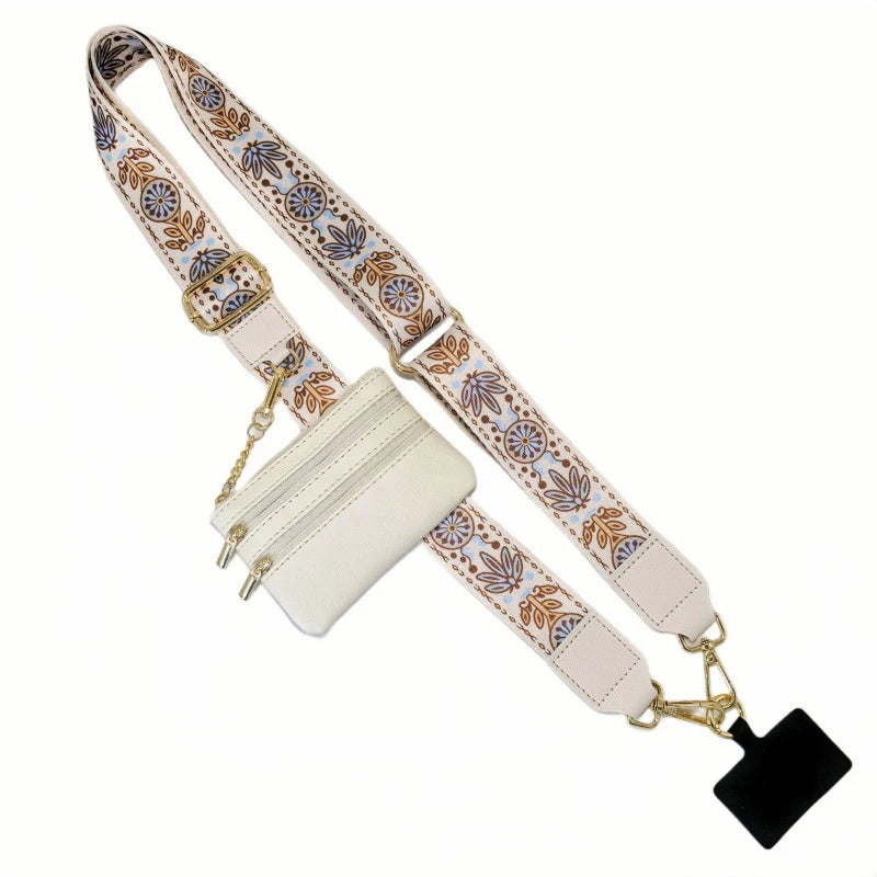 A beige phone lanyard with a decorative patterned strap and a detachable leather wallet.
