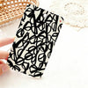 A black and white patterned card holder featuring a dense, abstract line drawing of flowers or leaves.