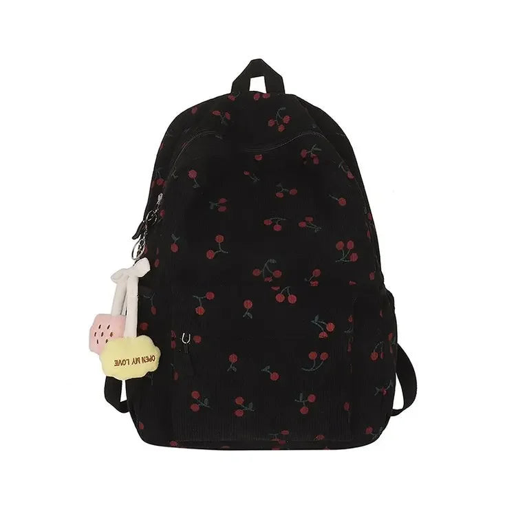 Black corduroy fashion backpack with a pink adjustable strap and small red floral embroidery