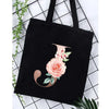 Black canvas tote bag featuring an alphabet floral print design.