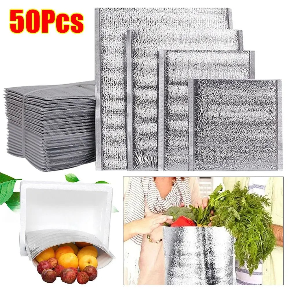 A stack of 50 insulated thermal food delivery bags with aluminum foil lining, shown next to a person preparing food.