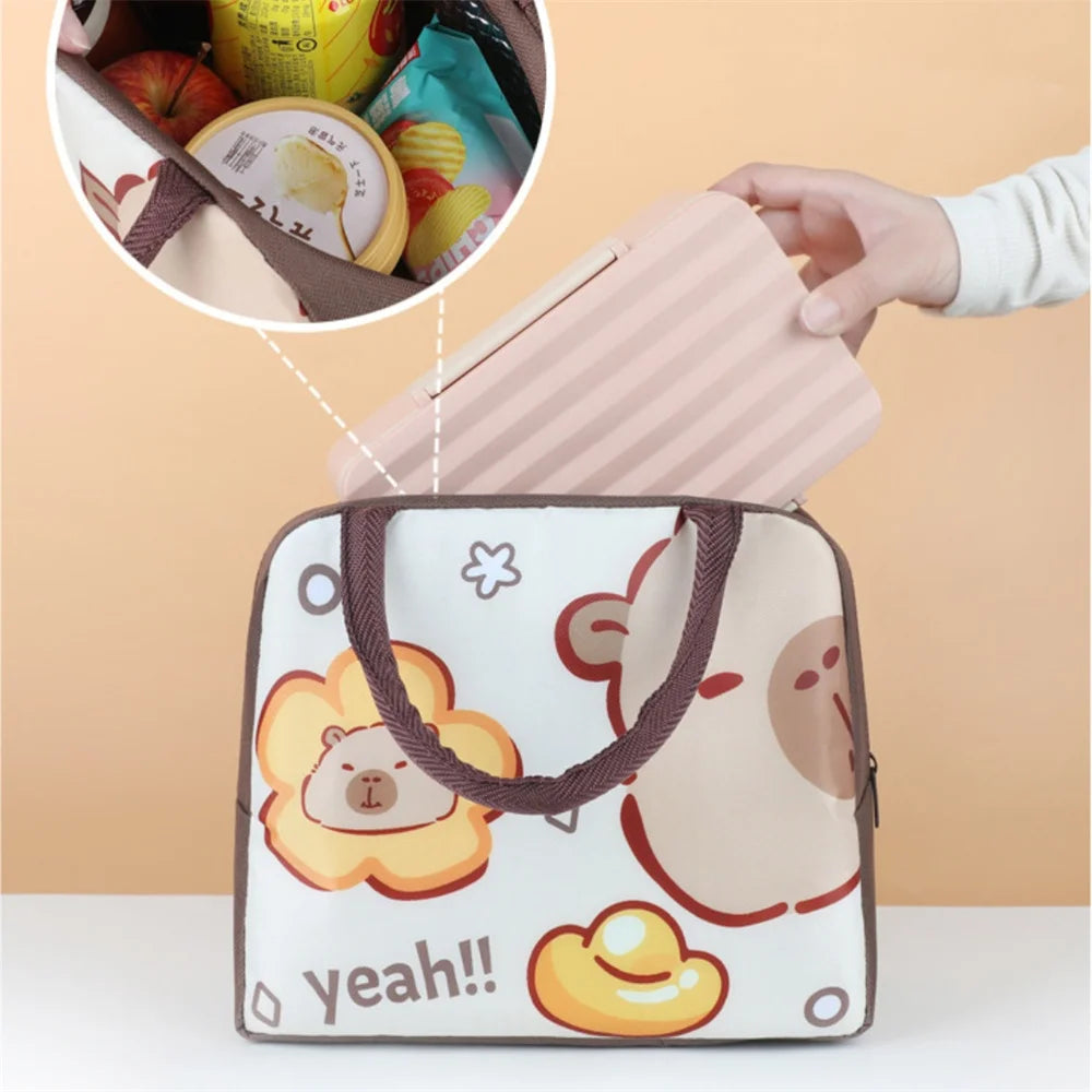 A pink and white cartoon capybara insulated lunch bag is shown with a detail view of its interior.