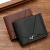 A dark brown leather bifold wallet is shown resting on a wooden surface.