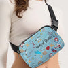 A woman wearing a white top holds a blue medical doodle print crossbody waist bag.