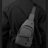 A black lightweight nylon crossbody sling bag worn on a person's back.