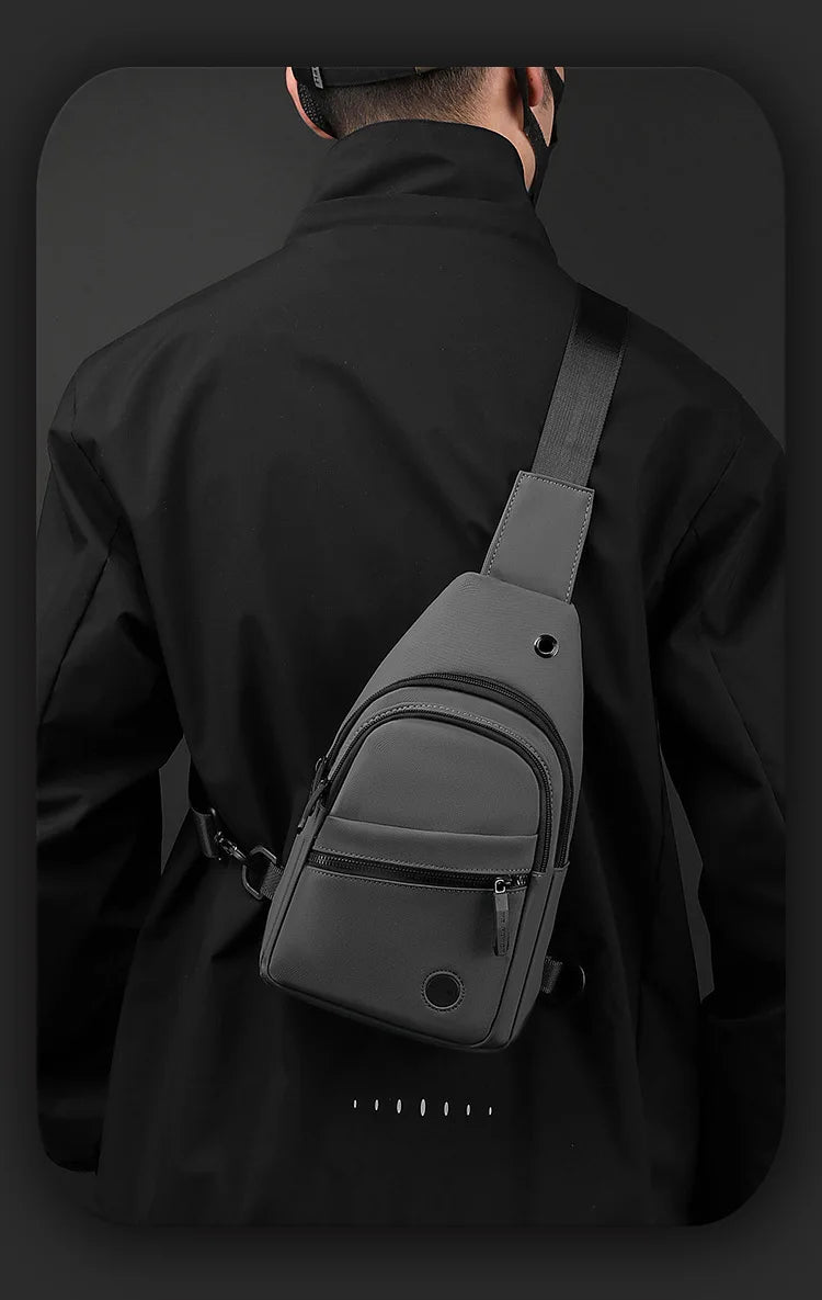 A black lightweight nylon crossbody sling bag worn on a person's back.