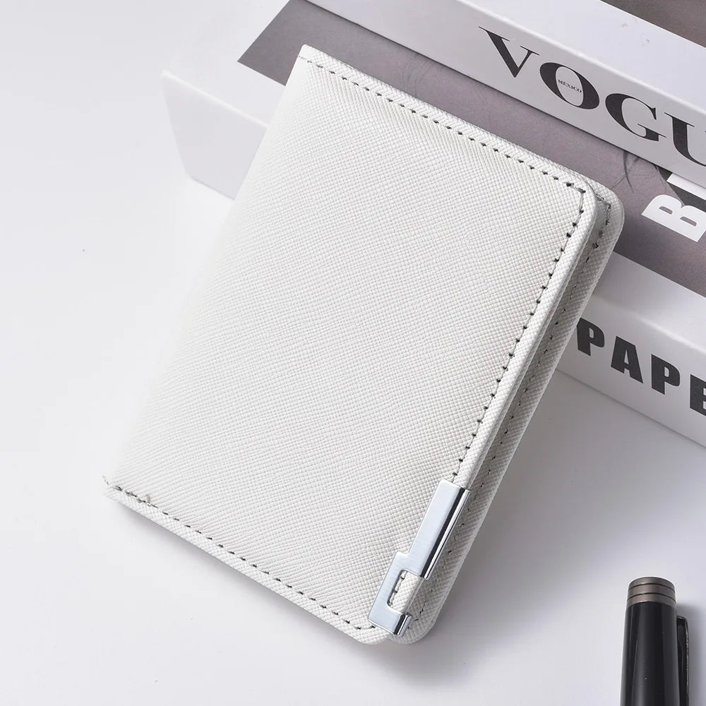 A slim vertical card wallet in light beige leather with a stitched edge resting on a white surface.