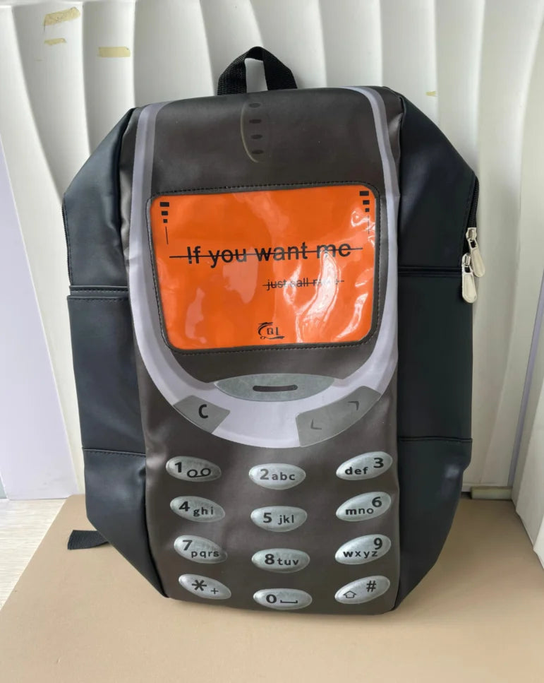 A dark gray backpack featuring a keypad design on the front, suitable for a vintage Y2K telephone theme.