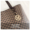 A close-up of a brown faux leather tote bag with a monogram print and gold hardware.