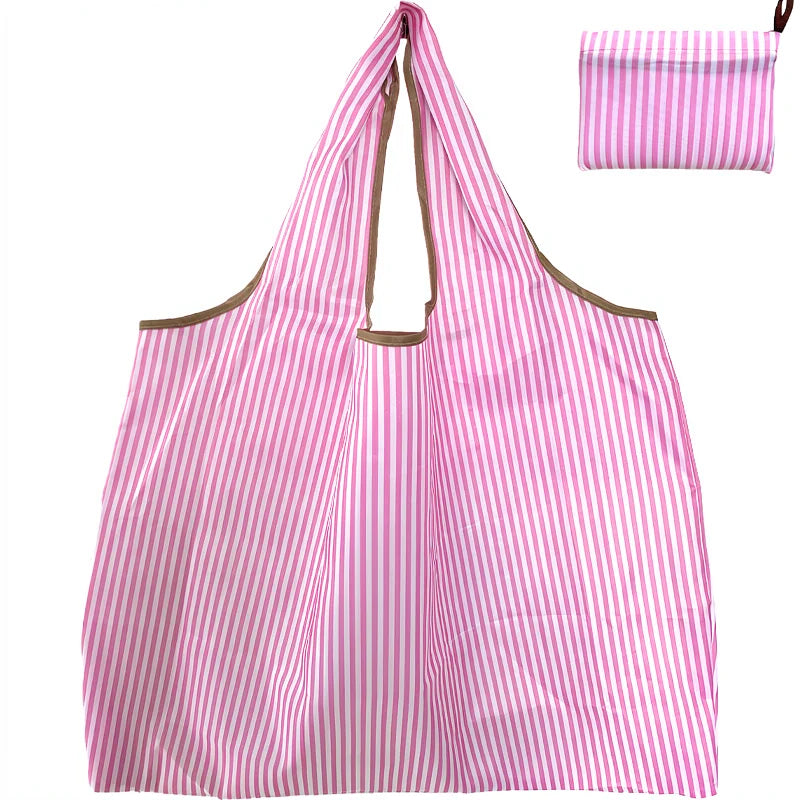 Pink and white striped foldable oxford grocery tote bag with a matching striped pouch.