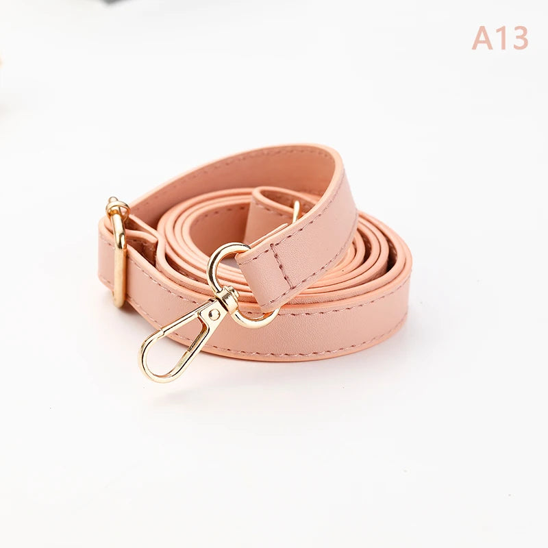 A roll of light pink PU leather crossbody bag strap with a gold-toned metal clasp.