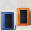 A close-up of an orange slim PU leather mini wallet with a black card slot, next to a blue version.
