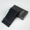 A black carbon fiber money clip is displayed next to its original packaging.