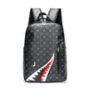 A black plaid laptop backpack with gray and white patterns shown from the back.
