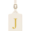 Étiquette de bagage beige en cuir rectangulaire avec une lettre J brodée en or et un clip métallique argenté.