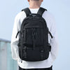 A black durable travel backpack worn by a man, shown from the back.