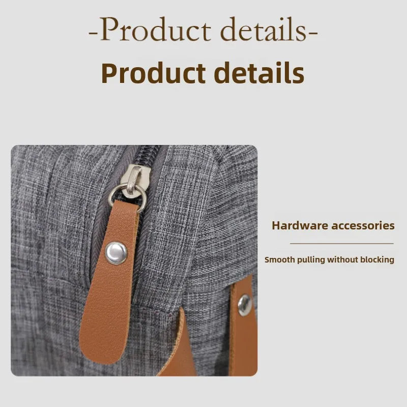 Close-up of a gray fabric pouch with a brown leather pull tab and metal hardware accessories.