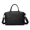 A black durable nylon travel duffle bag with a top handle and shoulder straps.