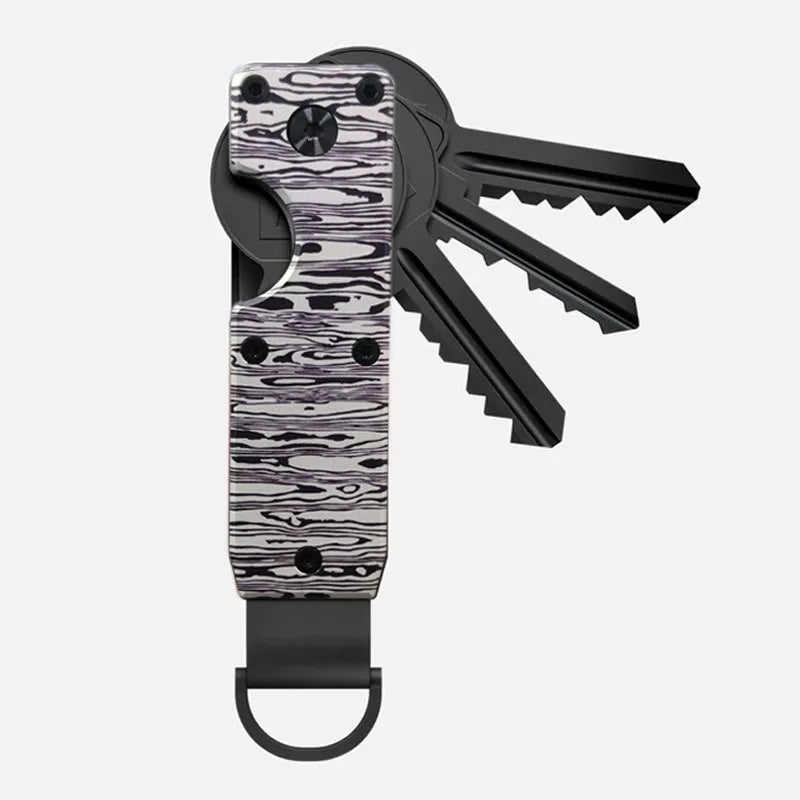 Porte-clés organisateur à clé en métal minimaliste avec motif marbré noir et blanc.