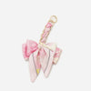 Pink floral fabric bow with a gold chain strap extension for a handbag
