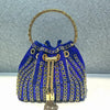 A royal blue crystal-embellished evening clutch with a gold chain handle and tassel.