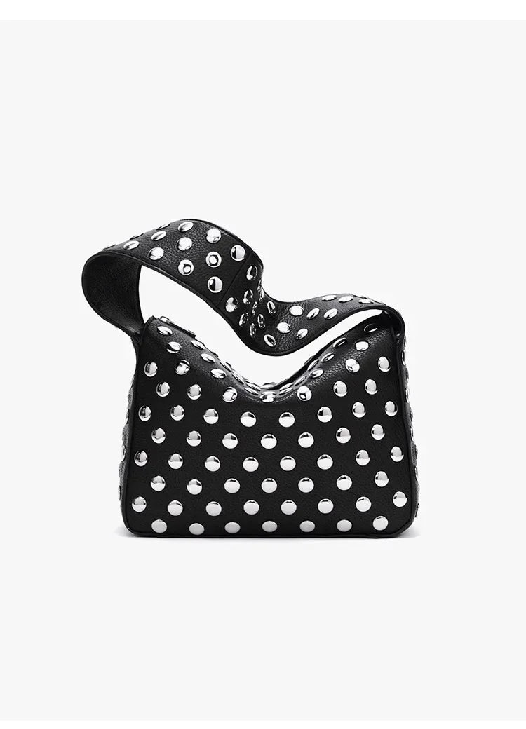 Black designer shoulder bag covered in silver metal rivets