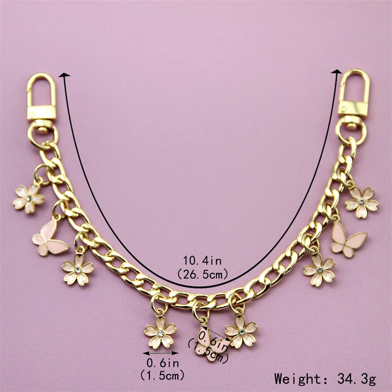 Gold chain necklace with flower charms and a butterfly charm, measuring 10.4 inches.
