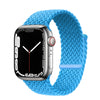 A silver Apple Watch is shown with a bright blue braided stretch band wrapped around it.