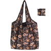A reusable fashion shopping tote bag in brown and beige patterned fabric shown folded.