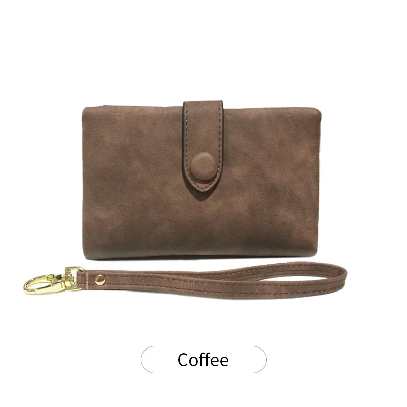 A brown leather card wallet with a flap and a matching leather strap.