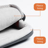 Close-up view of a gray fleece-lined laptop sleeve with a zipper and handle detail.