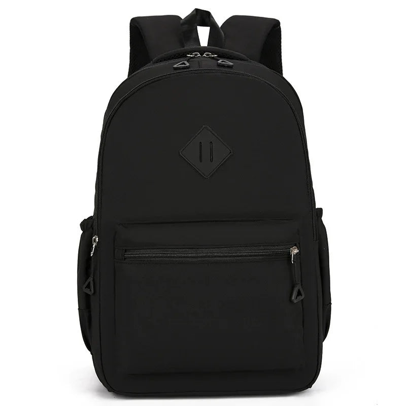 A black durable nylon commuter backpack shown from the back.
