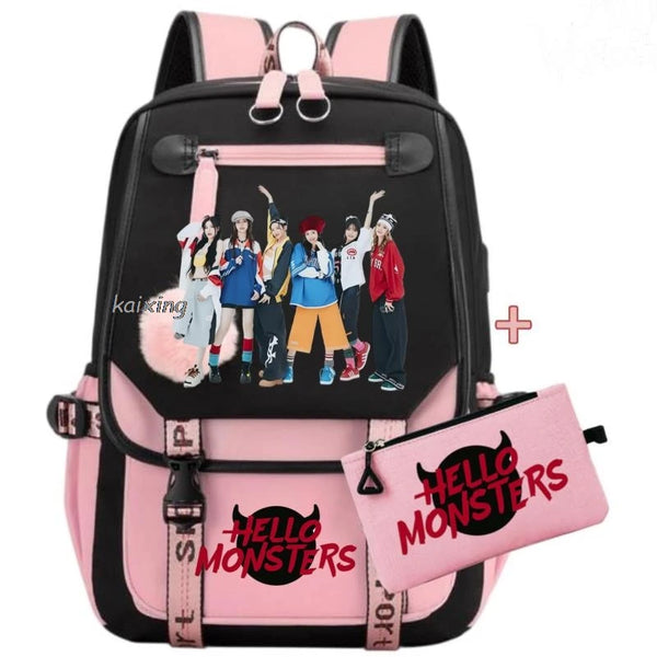 A pink and black canvas school backpack set with straps and pockets for students.