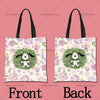 A pair of light-colored canvas tote bags featuring a cartoon dog design surrounded by purple and green flowers.