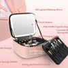 A pink LED lighted makeup mirror case with storage compartments and a brush holder.