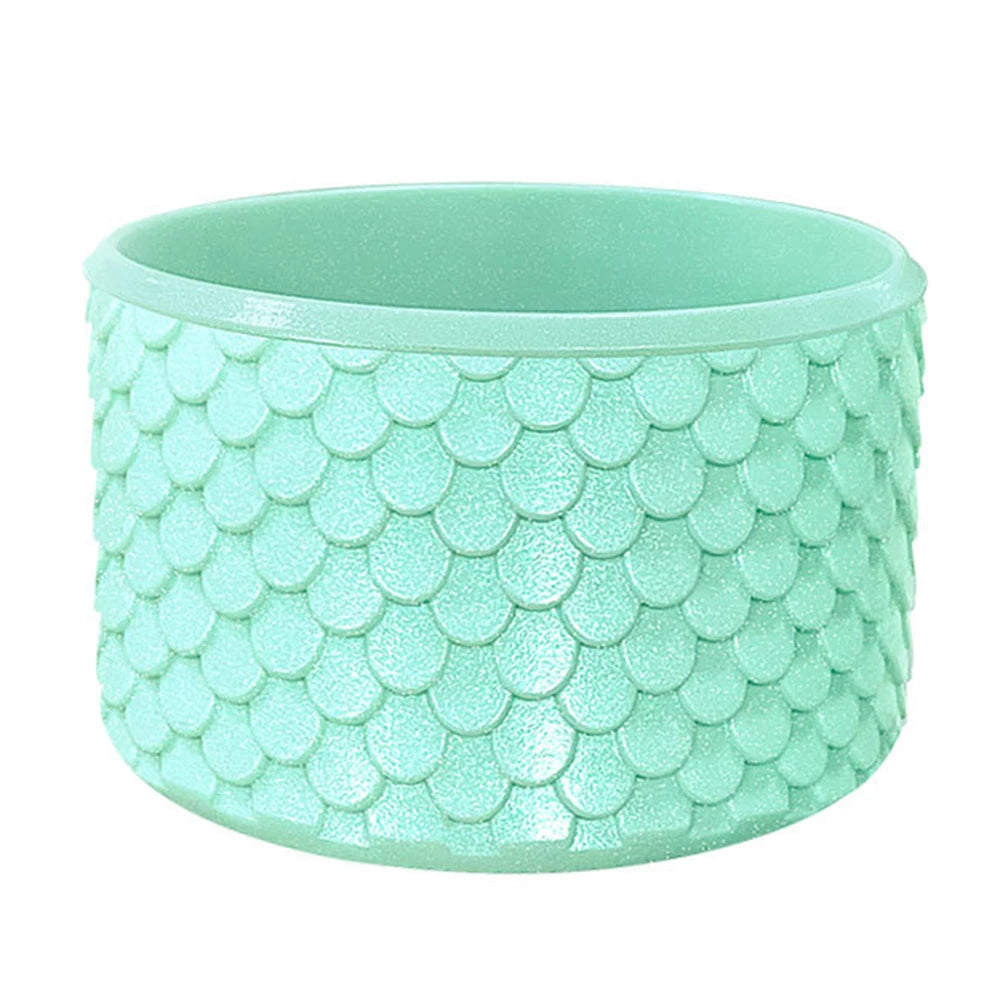 A light mint green silicone boot sleeve designed to fit water bottles.