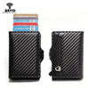 Black slim wallet with a carbon fiber pattern and a zipper closure, next to a stack of cards.