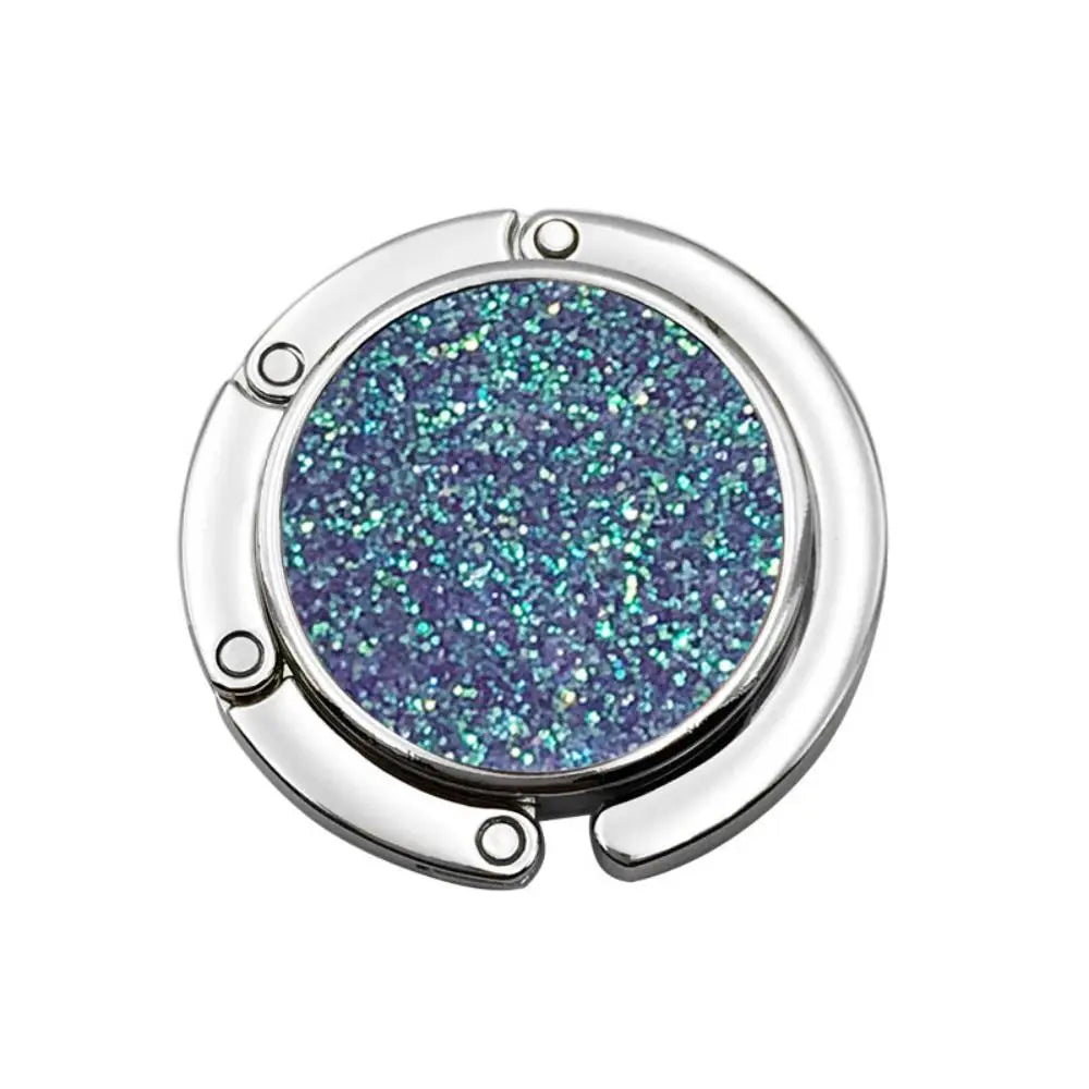 Silver metal desk hooks with a round, glittery purple gemstone centerpiece