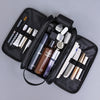 A black PU leather travel toiletry bag with multiple organizer pockets and various grooming tools is shown.