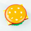 A yellow foldable card holder wallet with a round flap featuring white polka dots and red trim.
