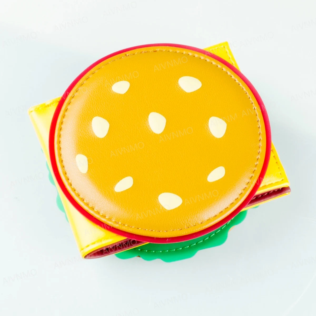 A yellow foldable card holder wallet with a round flap featuring white polka dots and red trim.