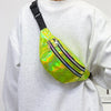 A bright holographic sequin waist bag with black stripes and an adjustable strap worn on a gray sweatshirt.