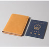 A brown leather passport and ticket holder with Chinese text and an emblem on a gray background.