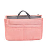 A pink fabric handbag with a gray lining and a black handle, featuring multiple internal pockets.