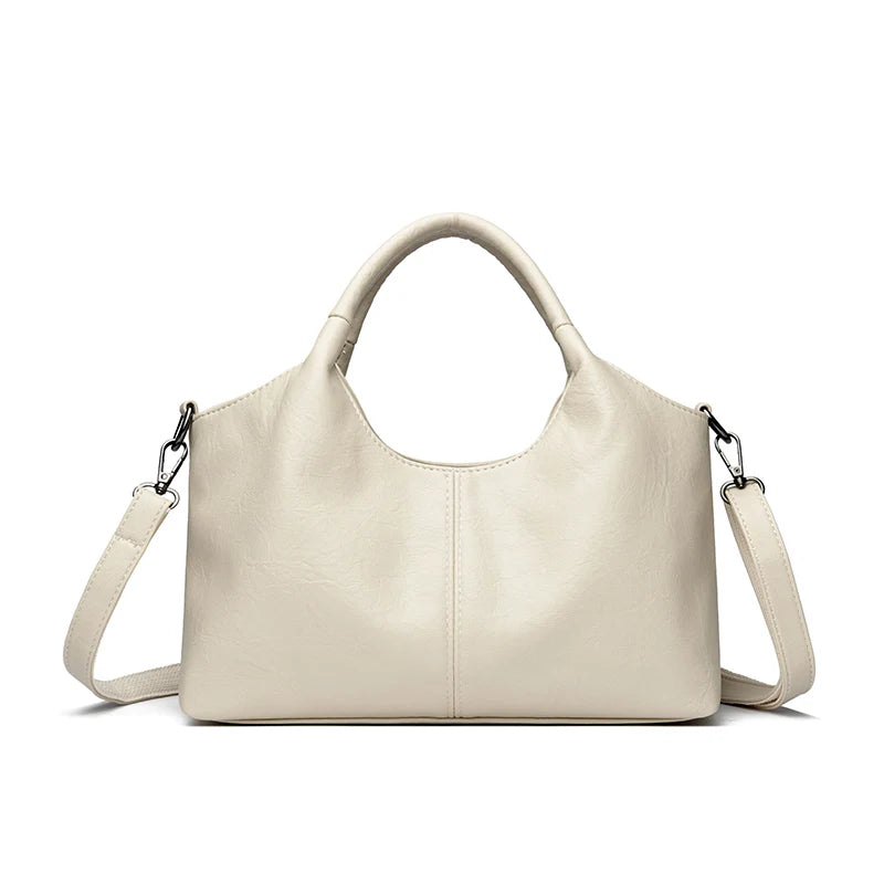 A beige leather women's casual crossbody shoulder bag with a zip closure.