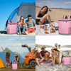 A woman is sitting on a pink insulated cooler backpack outdoors with food and a large orange van in the background.