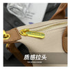 Close-up of a beige PU leather crossbody handbag featuring gold hardware and stitching details.